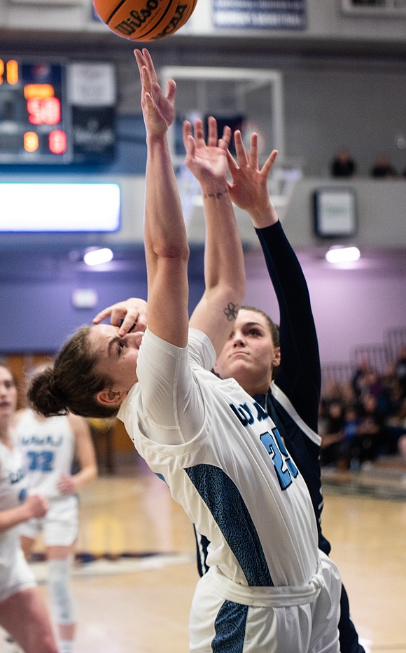 Maddy Grandbois is fouled as she puts up a layup.