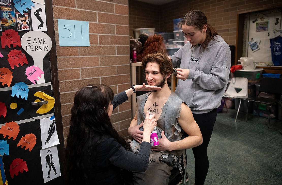 Senior Josiah Fox, center, gets the final touches to his makeup and hair styling 30 minutes before the first scene.