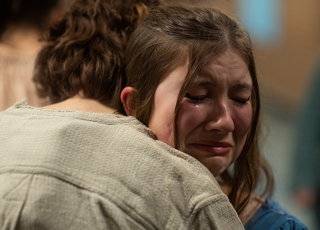 Senior Melina Saxman is embraced as she cries before the final show. "Les Mis" was Saxman's first play as an actress. She previously played in the pit orchestra for the production of "Newsies."