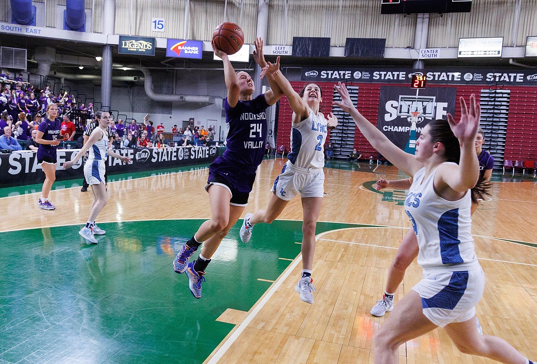 Nooksack Valley’s Devin Coppinger drives for a layup over Lynden Christian's Demi Dykstra and Grace Hintz as the Pioneers beat the Lyncs 43-36 in the 1A state championship March 4. Coppinger was named the Northwest Conference Player of the Year while Hintz and Dykstra made the All-NWC First Team.