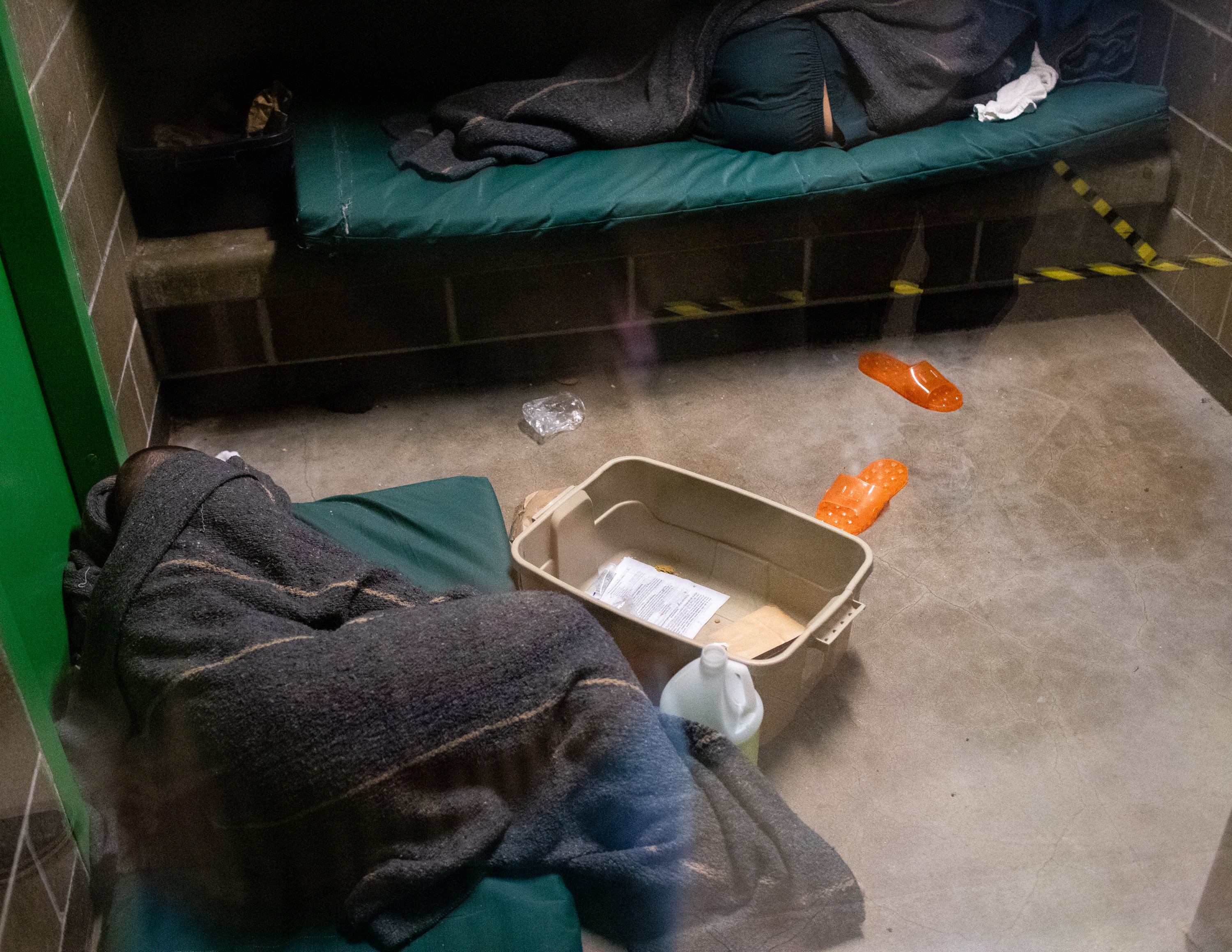 Two inmates sleep in their cell, including one on a mat on the floor, at the Whatcom County Jail in November 2022. The downtown jail, built with a capacity of 148 inmates, routinely holds about 190.