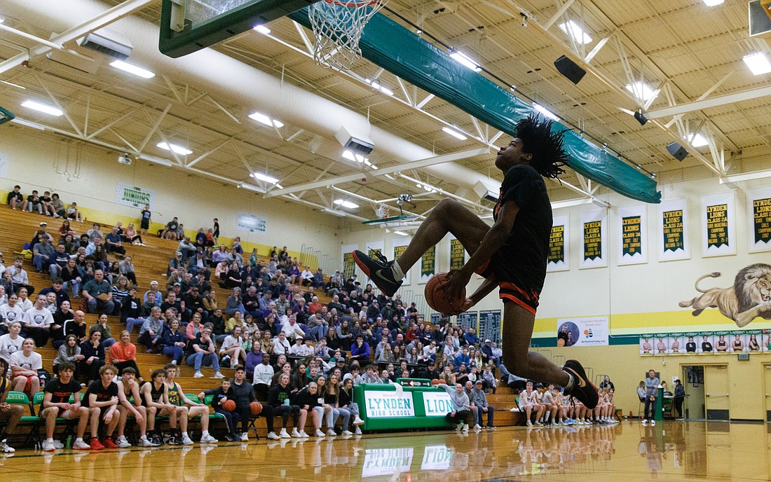 Blaine's Mathew Russ attempts a between-the-legs dunk March 10 during the dunk contest at the 2023 Whatcom County Senior Classic at Lynden High School. The event included boys and girls 3-point contests, extended games and a dunk competition.