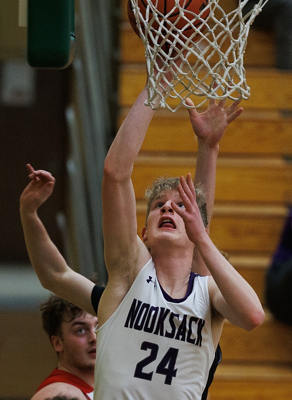 Nooksack Valley’s Ayden Roper puts up a basket during the boys game.