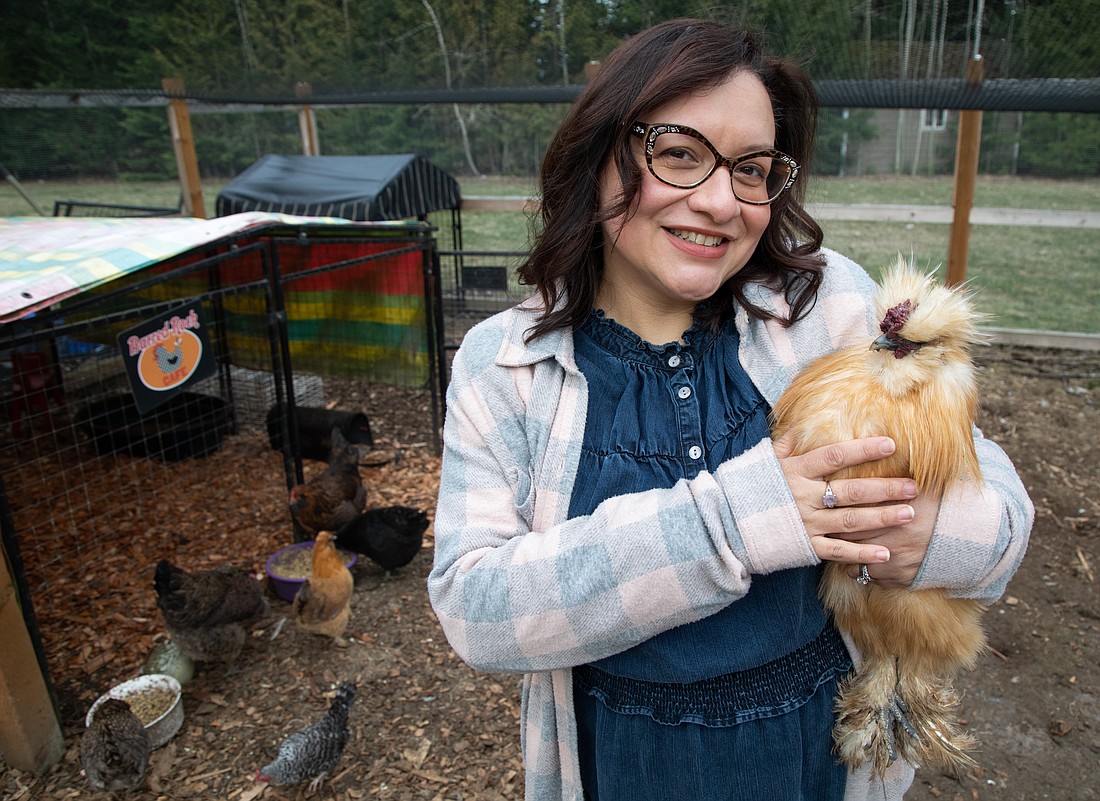 Dalia Monterroso holds Bubbalicious, a silkie rooster, in her backyard coop March 9 outside of Bellingham. Monterroso has more than 75,000 subscribers to her YouTube channel "Welcome to Chickenlandia," where she teaches people about keeping backyard chickens.