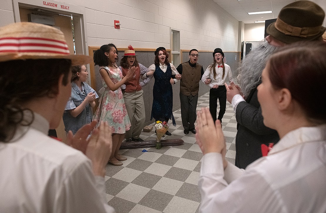Actors of the Bellingham High School drama program warm up during traditions in the hallway backstage about 20 minutes before the show.