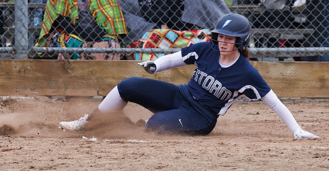 Squalicum’s Olivia Paoli slides safely into home plate for the run as the Storm beat Ferndale 3-0 in a fastpitch softball game on April 13, 2022.