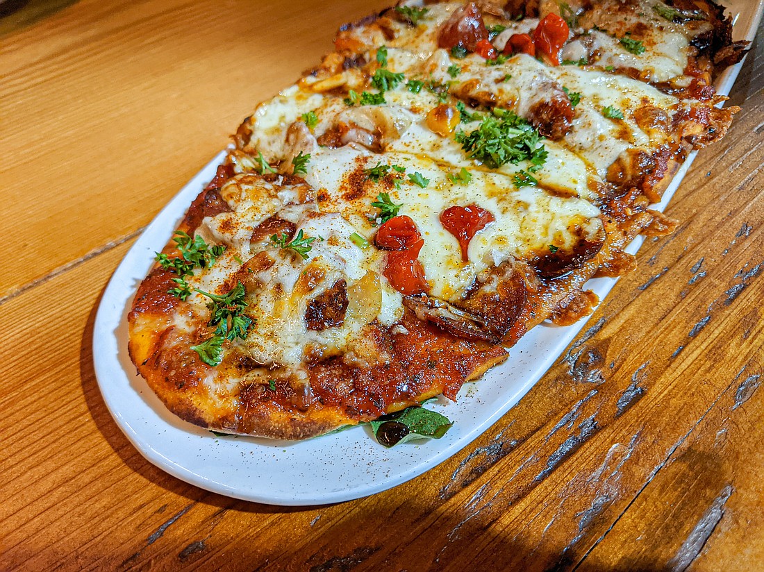 Spanish flatbread is one of the menu items available at Penny Farthing, Chuckanut Bay Distillery's restaurant on Cornwall Avenue. Toppings include sun-dried tomato sauce, spicy chorizo and a ton of roasted garlic, adorned with a few tiny sweet-hot peppers.