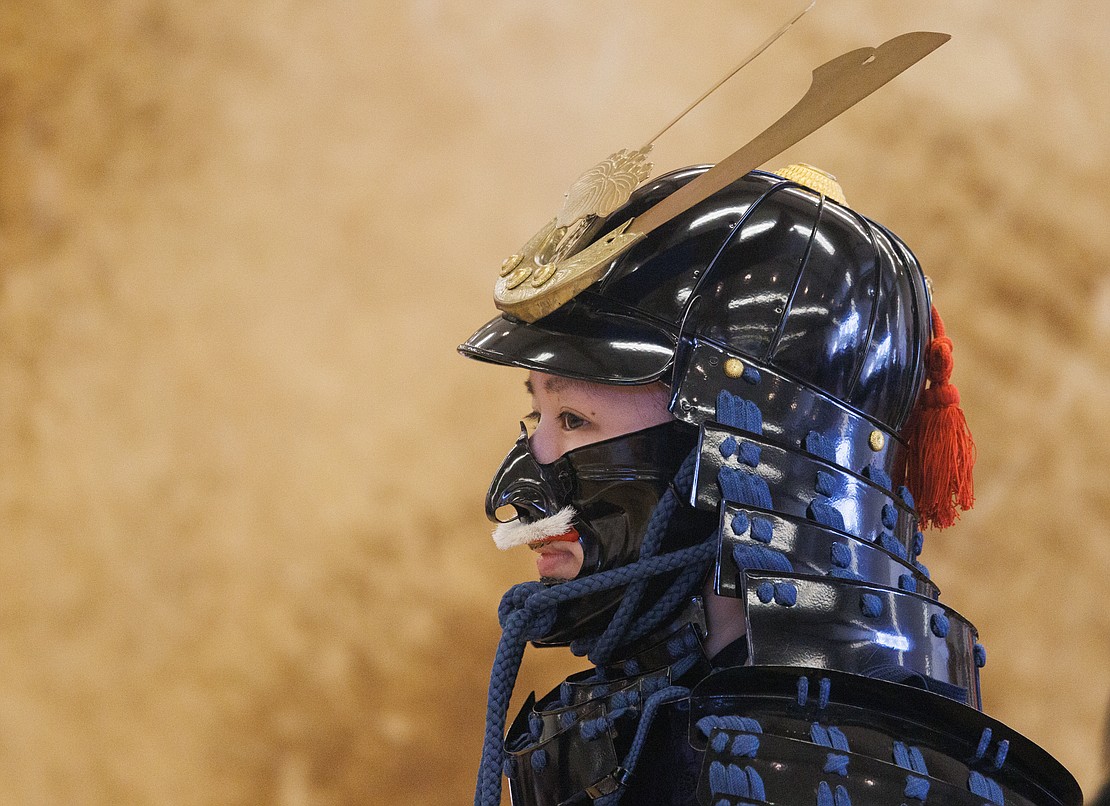 Hitomi Onomichi wears Samurai armor during a demonstration of how to put on the suit.