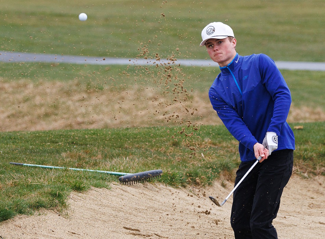 Lynden Christian’s Griffin Dykstra hits out of a bunker March 20 as Squalicum, Meridian and Blaine golfers compete at North Bellingham Golf Course in Bellingham.