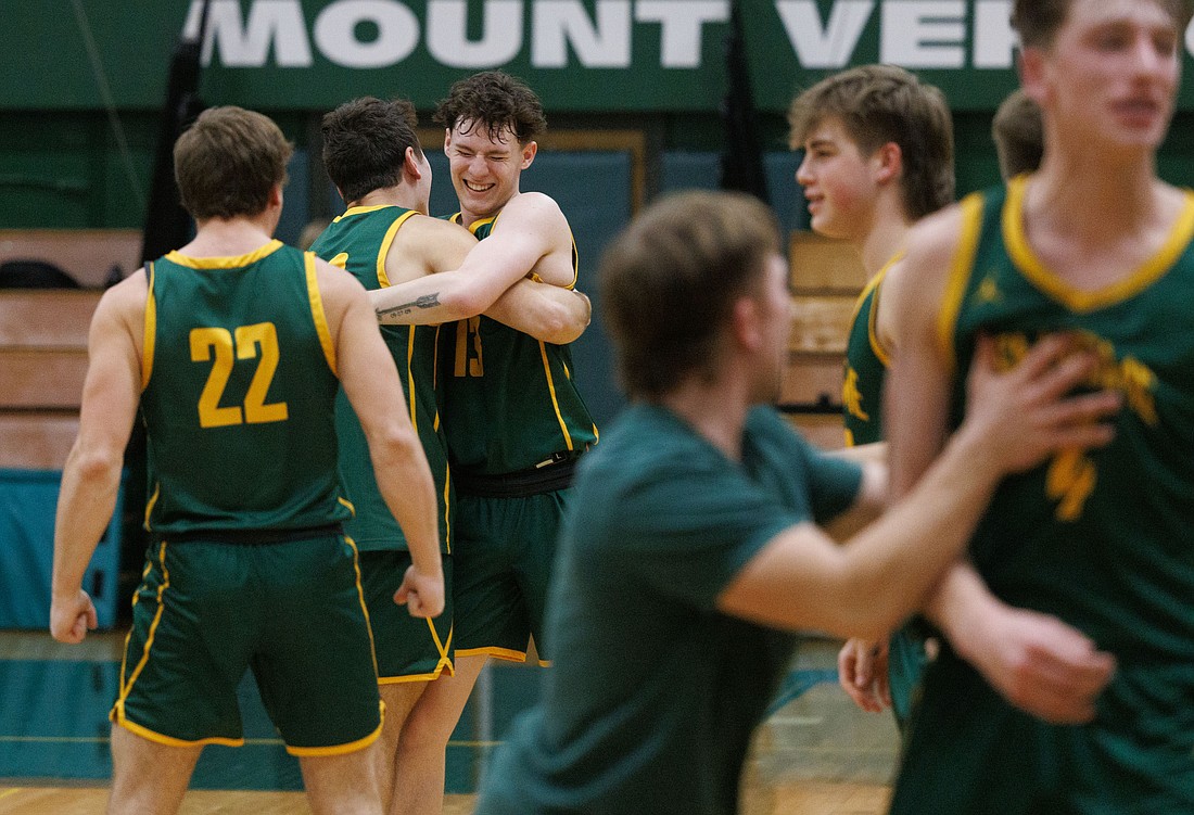 Sehome's Mat Storms, facing, and teammate Nate Eisses hug Feb. 14 after Sehome beat Lynden 46-44 in the 2A District 1 semifinal game at Mount Vernon High School. Storms committed to Western Washington University as a walk-on March 16.