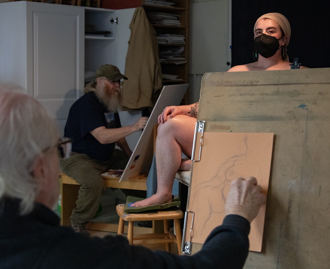 Leo Morningstar poses while Michael Heath, back, and Len Shaffer work on their life studies March 17 in Bellingham. Mary Morton organizes the event every Friday and Saturday as a chance to give both established and burgeoning artists a chance to hone their skills.