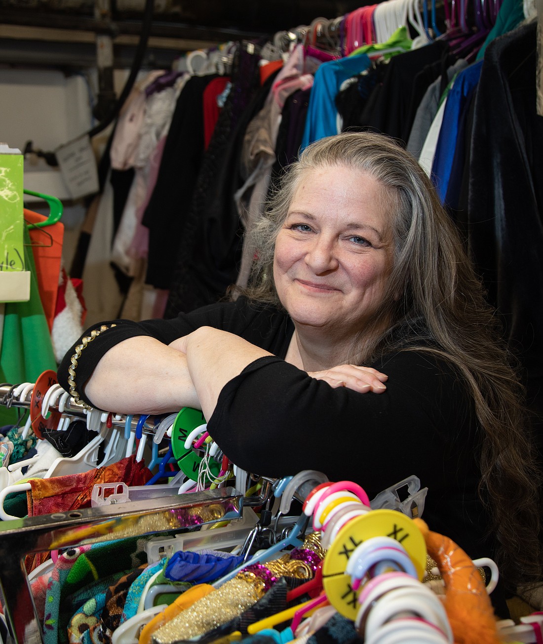 Dana Crediford stands in the crammed-to-the-gills costume shop at Bellingham Arts Academy for Youth (BAAY). Three years, ago, she started her costume mentoring program with two kids. This year, there are 50 students in the program.