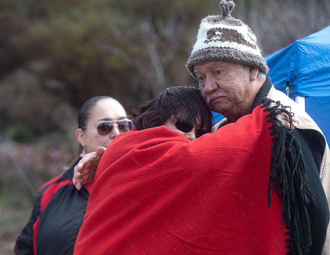 Charlene Casimir of the Lummi Nation hugs William John before leaving the rally.