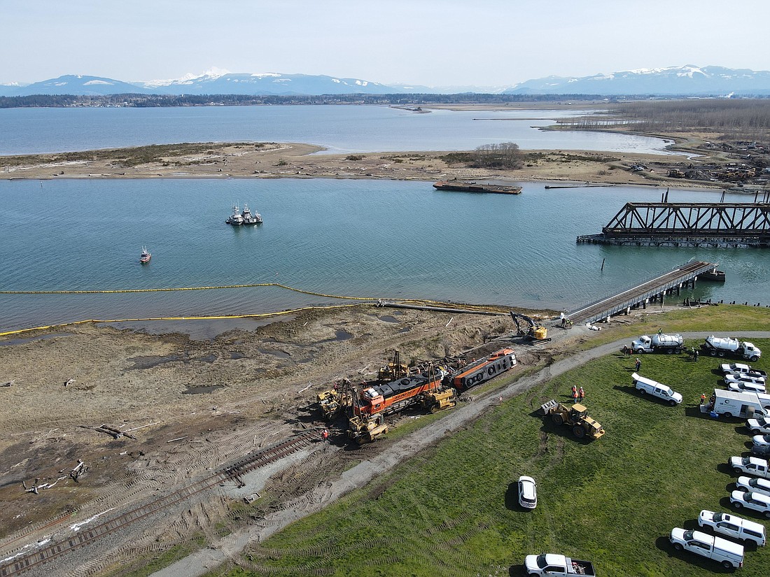 Crews work to remove a pair of Burlington Northern Santa Fe locomotives that derailed on the Swinomish Reservation in Skagit County on March 16. A federal judge has ruled that BNSF knowingly violated an agreement limiting freight train traffic on the reservation.