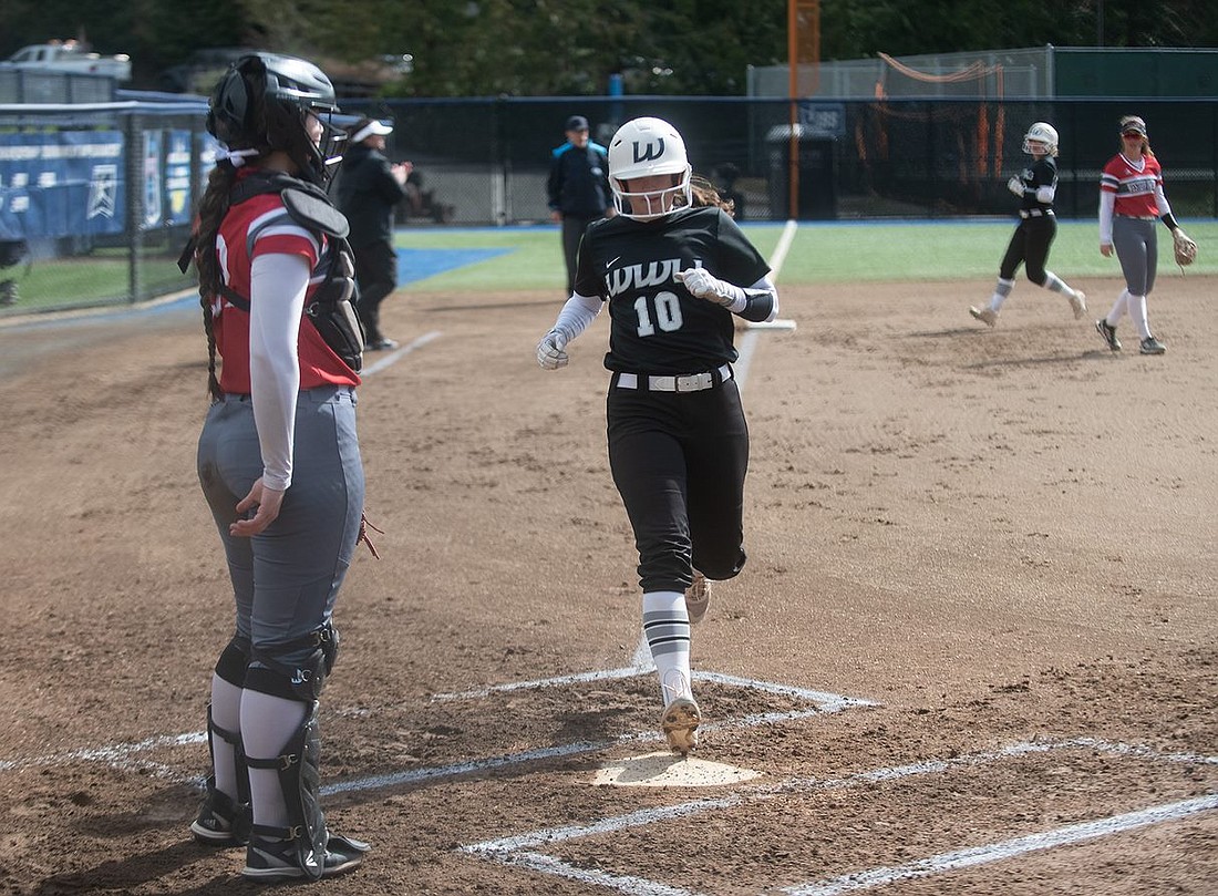 Western Washington senior designated player Kinzey Williams scores on an RBI walk by Amaya Davis March 26 in the first inning of the first game of a four-game series against Western Oregon at Viking Field.