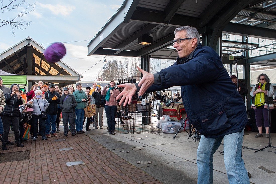 Mayor Seth Fleetwood tosses a cabbage April 1  at Depot Market Square to kick off the Bellingham Farmers Market's 31st season.