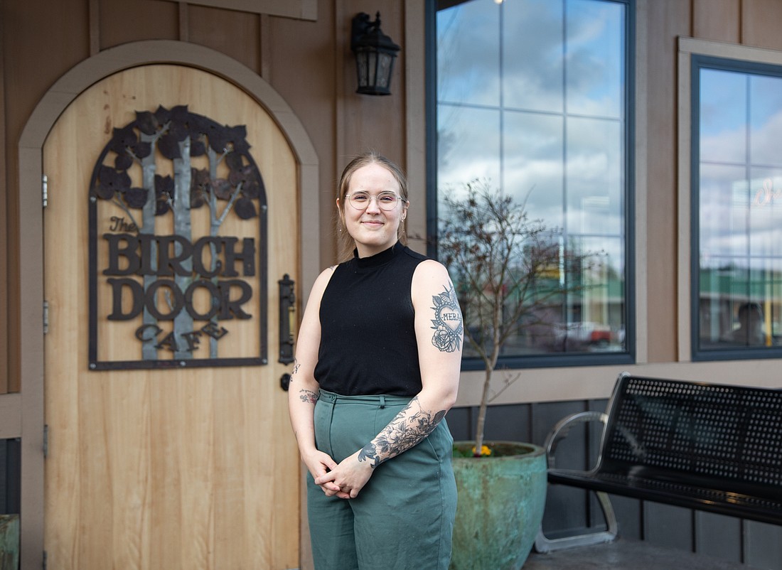 Faye Croixa stands outside of the Birch Door Cafe, where they have worked since the restaurant opened in 2017.