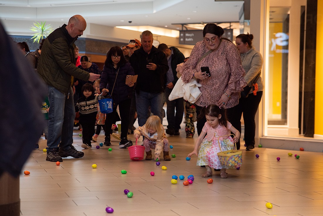 Children pick up Easter eggs at Bellis Fair April 8 during the mall's Easter egg hunt. Hundreds of kids showed up to search for 5,000 eggs hidden in common spaces around the mall.