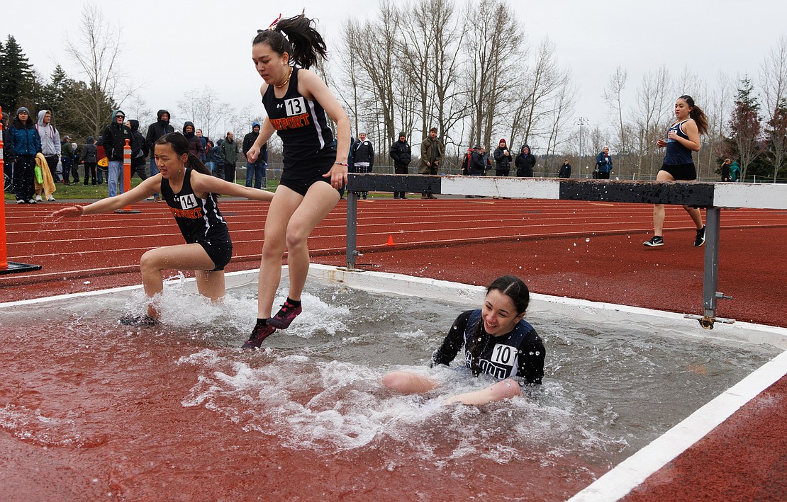 Grace Academy’s Brooklyn Crawford falls into the steeplechase pit during the 2000-meter race.