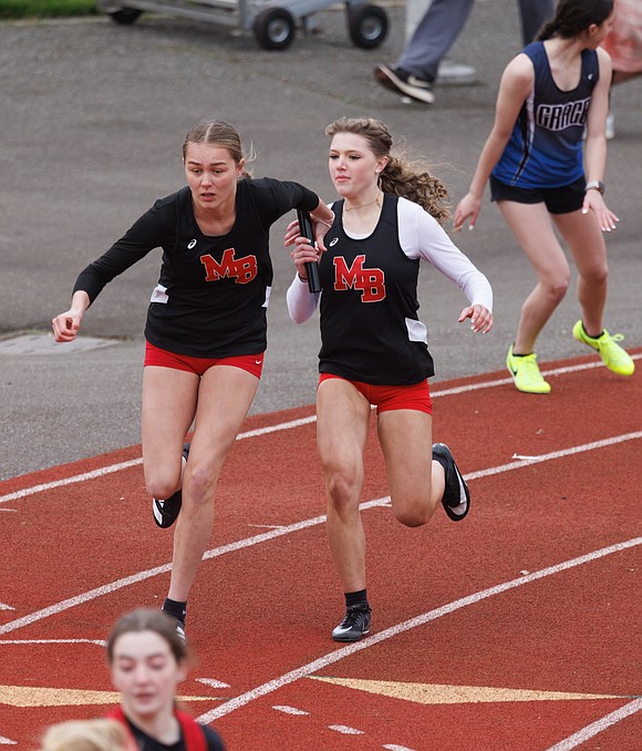 Mount Baker's Tyla Olson hands off to Adyson Moa in the 4X100-meter relay.