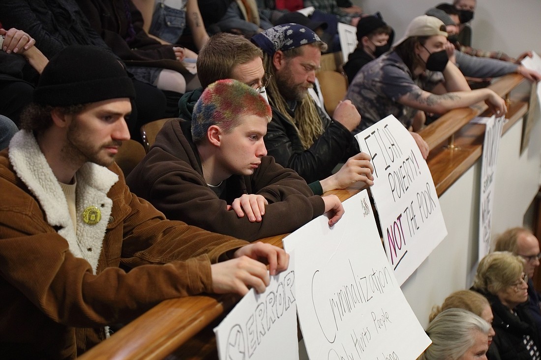 Meeting attendees hold signs at an April 10 Bellingham City Council meeting at City Hall to protest the criminalization of public drug use.