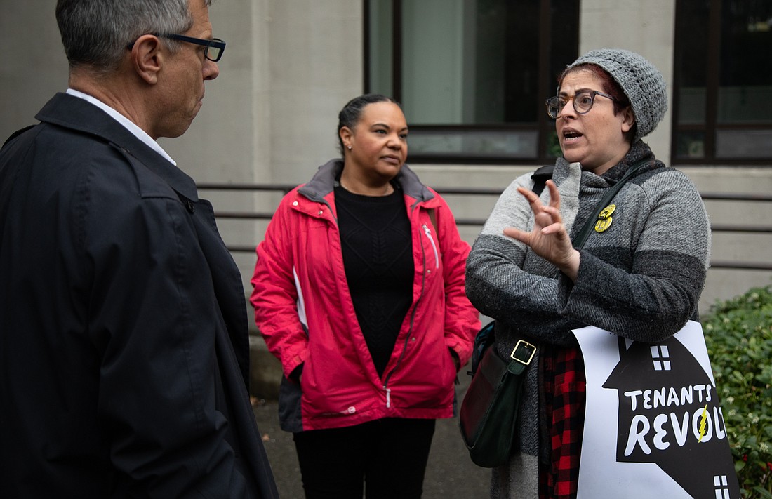 Rebecca Quirke, right, of Tenants Revolt talks to Mayor Seth Fleetwood, left, and Kristina Michele Martens about the state of rental housing April 10 prior to a Bellingham City Council meeting.