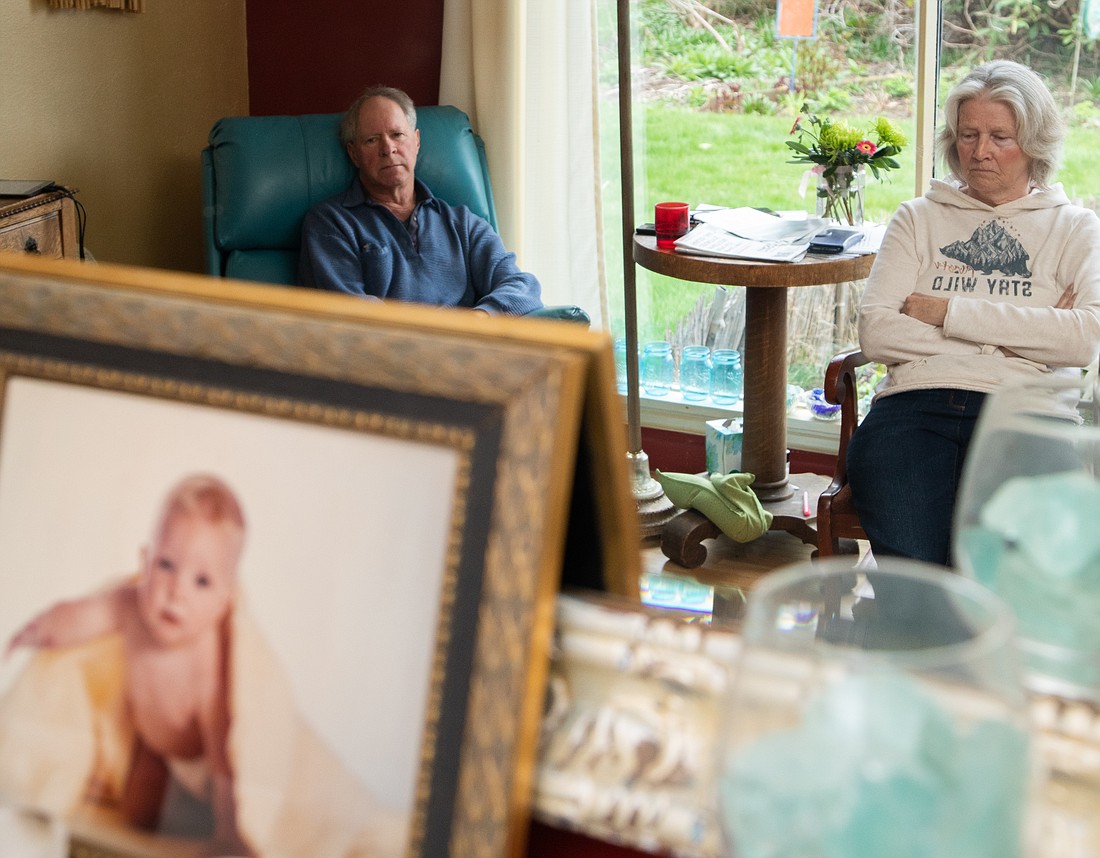 A portrait of Mick Satushek as an infant sits on the mantel, as a mirror reflects his father Steve Satushek and his aunt Becky Klein at Mick's childhood home in Bellingham April 15. The family called him a "Gerber Baby" because of how cute he was. Mick died at age 29 on April 5 in the Arne Hanna Aquatic Center. He had started smoking fentanyl about a year earlier.