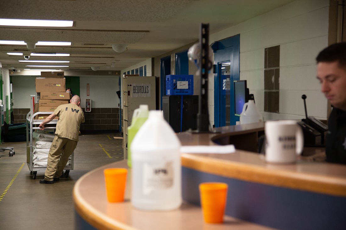 Inmates move pantry items through the first floor of the Whatcom County jail in November 2022.