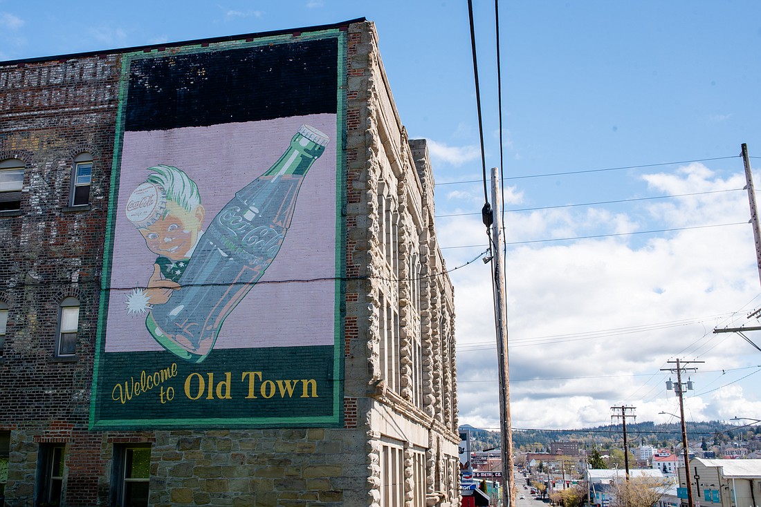 A mural on West Holly Street reads "Welcome to Old Town." A new team of developers is buying up lots in the area for residential and commercial redevelopment.