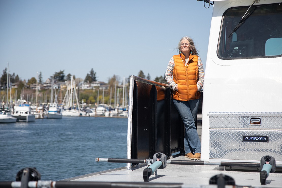 Mount Baker High School biology teacher looks out at Bellingham Bay while finishing her last field trip of the season aboard the Snow Goose. For nearly a decade, Koon has taken students out on the water.
