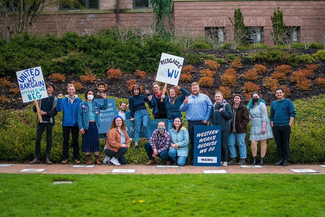 Members of the Western Academic Workers United stand outside Old Main at Western Washington University. A new state law gives the student workers at regional universities the right to bargain.