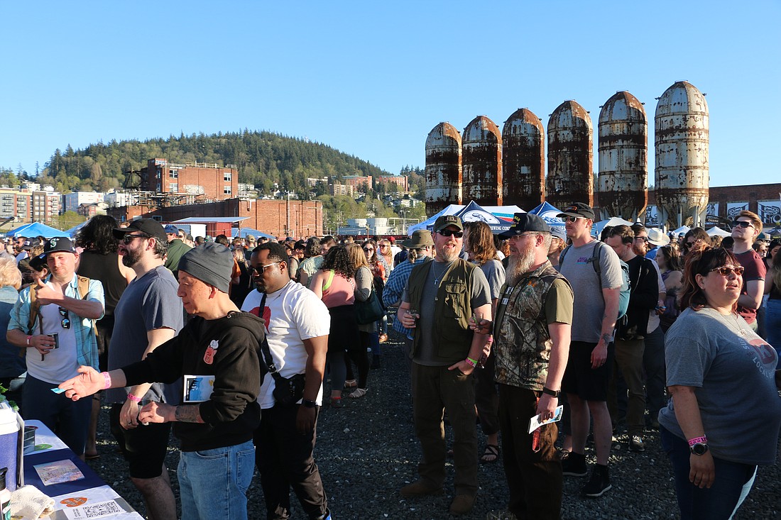 Attendees line up to receive a taste of beer from Birdsview Brewing Company during the April Brews Day festival April 29 at Bellingham's downtown waterfront. The festival returned after a three-year hiatus following the pandemic.