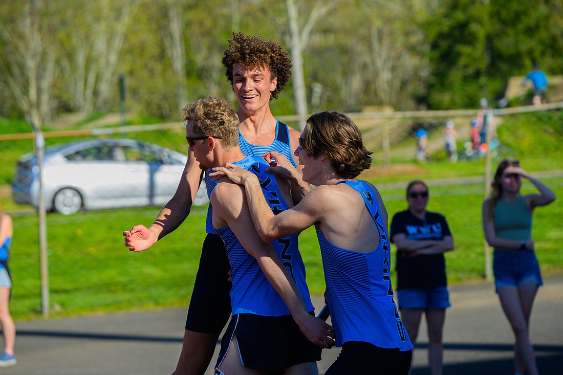 From left, Western Washington University sophomore Drew Weber is met by teammates Connor Palmen and Jonah Bloom April 29 after anchoring the men's 4X400 relay team that took first with a time of 3:17.67 at the Vikings-hosted Ralph Vernacchia Invitational at Civic Stadium.