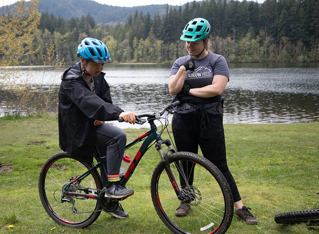 Clayton Chen, left, and mentor Ashley Rowles chat April 30 after finishing a ride around Lake Padden. Rowles is training Chen through the AIROW Project to race in Junior Ski to Sea on May 13.