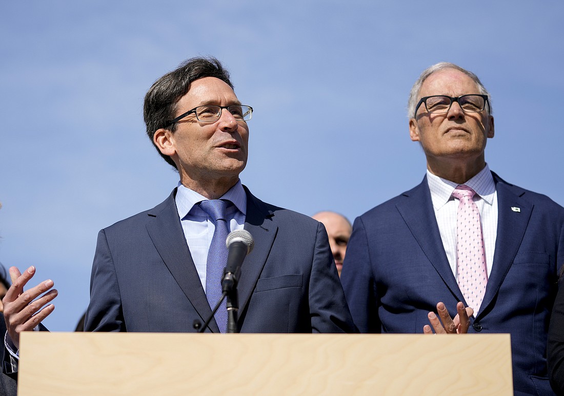 Washington Attorney General Bob Ferguson and Gov. Jay Inslee, right, speak before the signing of several bills on April 27 in Seattle. Ferguson launched an exploratory campaign for governor on May 2, one day after incumbent Inslee announced he would not run again.