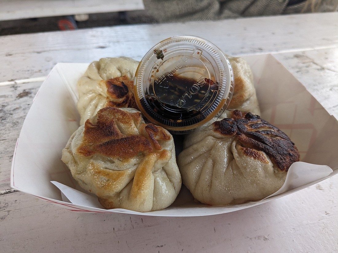The pork buns at the Dumpling Girls food truck parked at Goods Local Brews on Northwest Avenue feature massive fried bao filled with pork and vegetables — easily feeding two people of a lightly hungry persuasion.