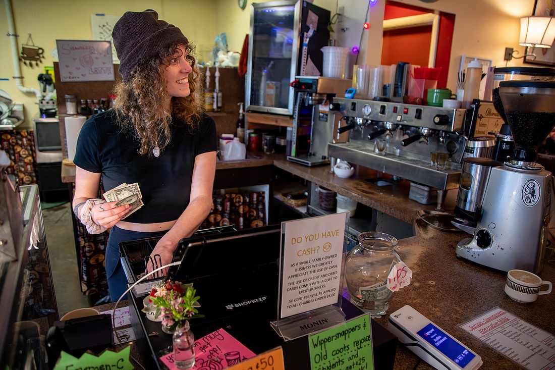 Barista Hannah Stine gives change May 5 at Bellingham's Avellino Coffeehouse. Like many small, local businesses, the coffee shop has an option to tip on its point of sale system and an old-fashioned tip jar.