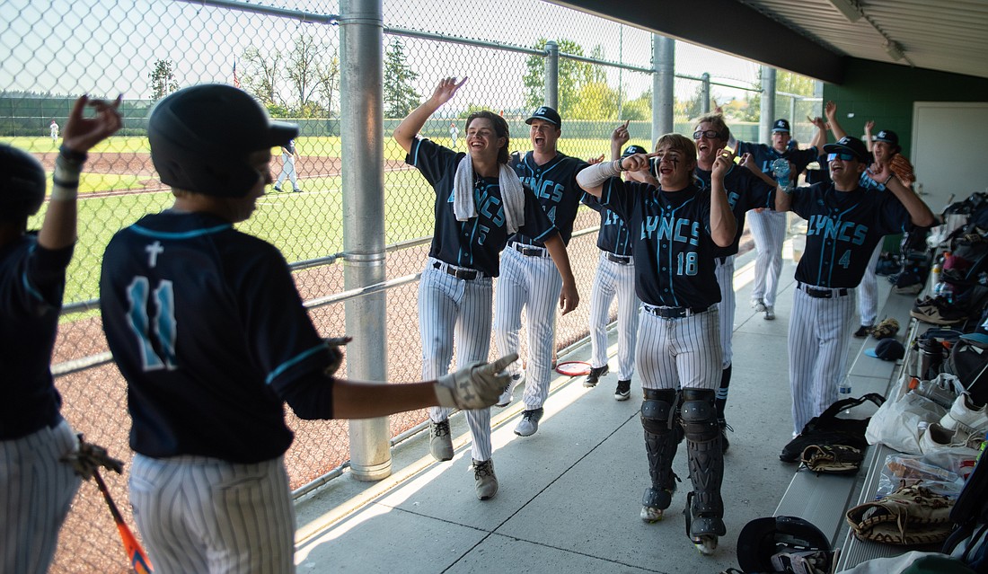 Lynden Christian welcomes senior right fielder Dexter Zylstra (11) back into the dugout May 13 after he scores against King's High School in the 1A District 1/2 playoffs at Sehome High School. The Lyncs won 12-0 to clinch a spot in the state tournament.