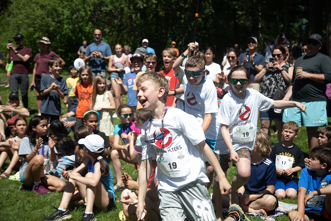 The Racebusters run for the podium after learning they won the elementary mixed division with a time of 42 minutes and 44 seconds.