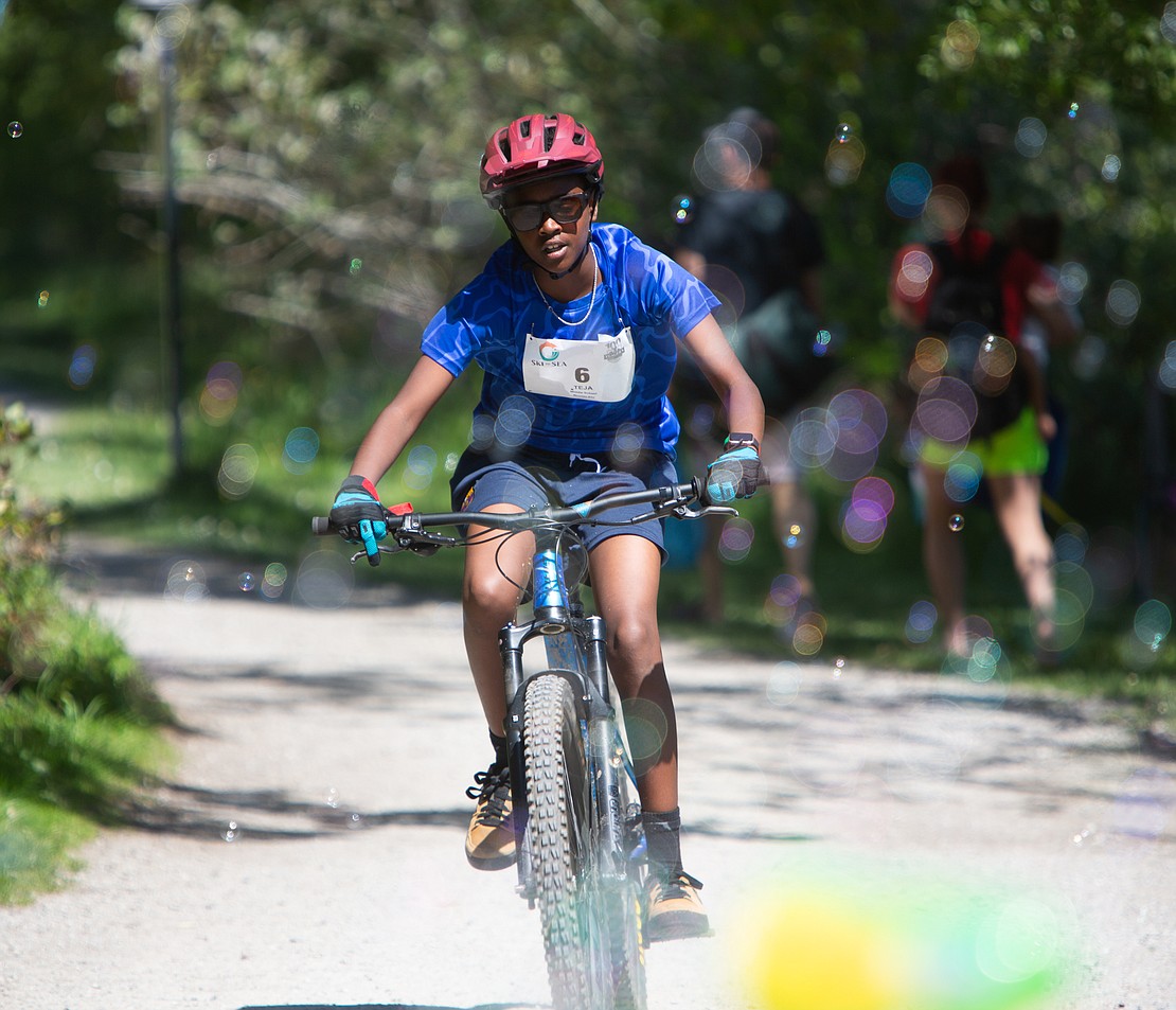 TEJA's Ever Rogel rides through bubbles on the race course.  His team won the middle school male division.