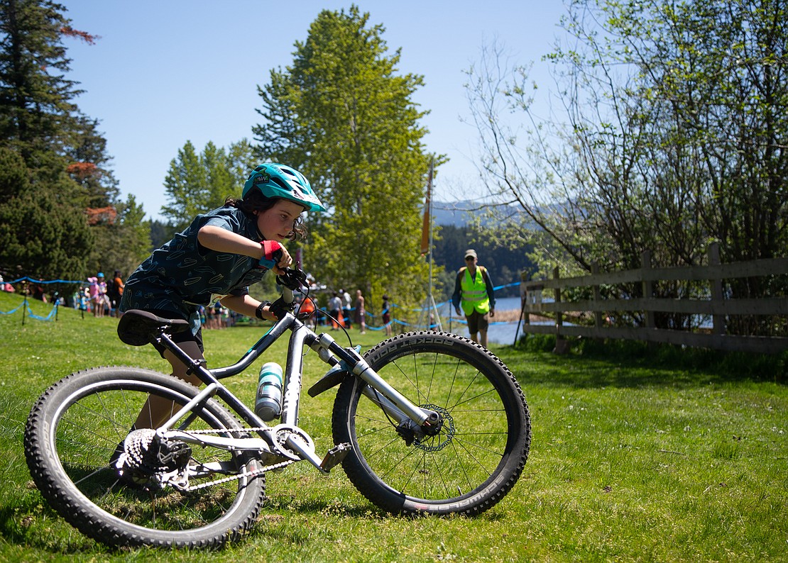 Henry McPhee of the Salish Sea Cucumbers grabs his mountain bike to begin his 2.6-mile ride around Lake Padden.