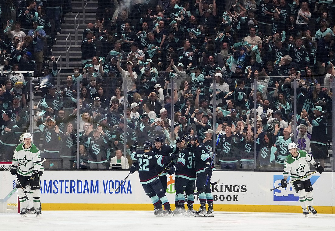 The Seattle Kraken celebrate a goal by right wing Eeli Tolvanen as Dallas Stars defenseman Esa Lindell, left, and center Wyatt Johnston (53) skate away during the second period of Game 6 of an NHL hockey Stanley Cup second-round playoff series May 13 in Seattle.