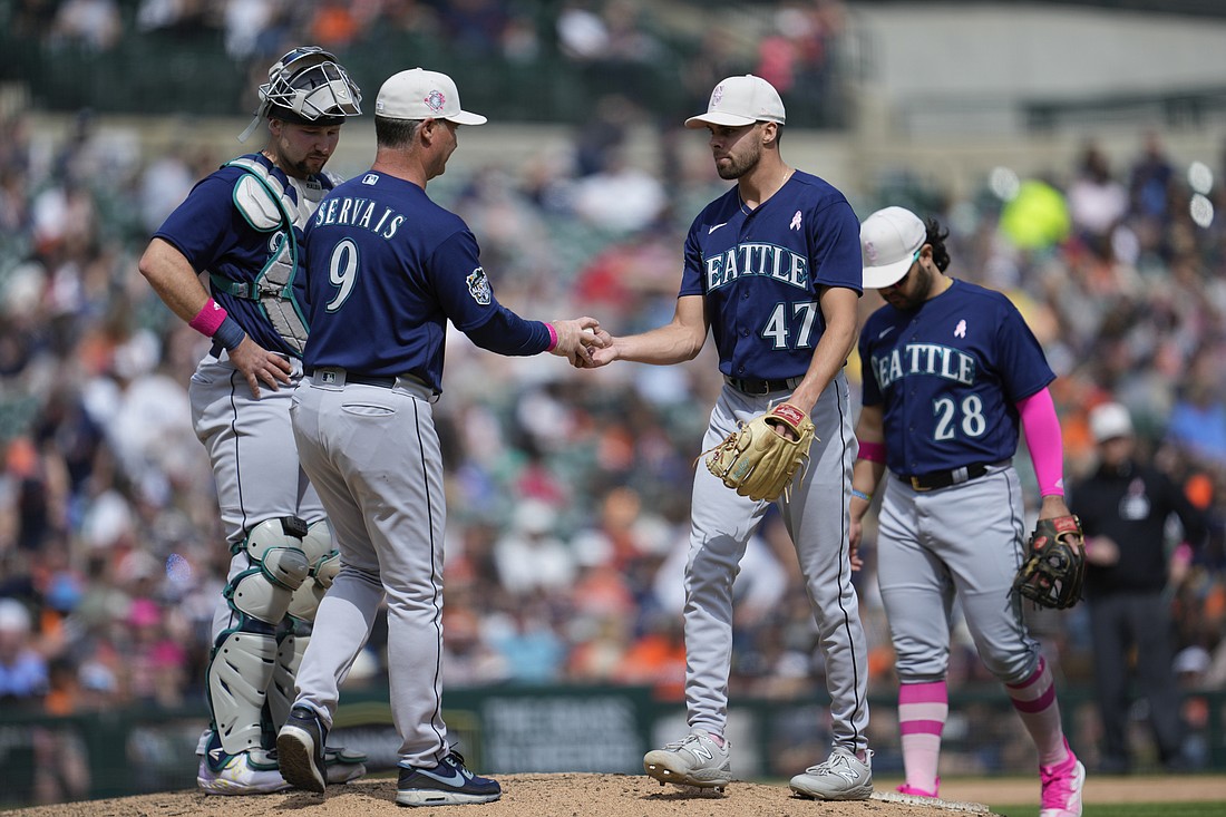 Seattle Mariners manager Scott Servais (9) takes the ball from relief pitcher Matt Brash (47) in the seventh inning of a baseball game May 14 in Detroit.