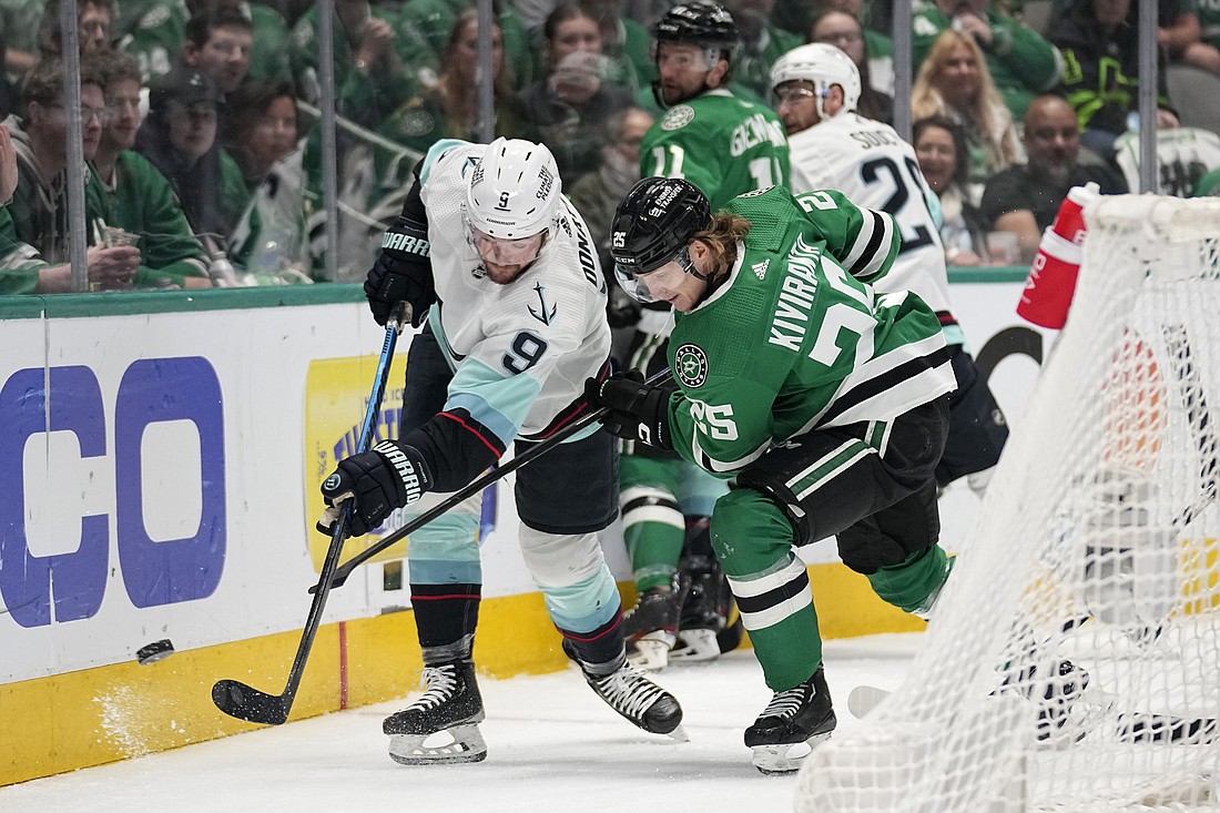 Seattle Kraken center Ryan Donato (9) clears the puck from behind the net under pressure from Dallas Stars left wing Joel Kiviranta (25) in the first period of Game 7 of an NHL hockey Stanley Cup second-round playoff series, Monday, May 15, 2023, in Dallas.