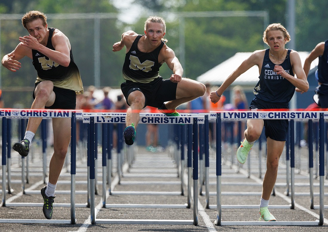 Meridian's Dane Beishline, center, clears the last hurdle on the way to winning his heat of the 110-meter hurdles May 18 at the 1A District 1/2 track and field meet at Lynden Christian High School.