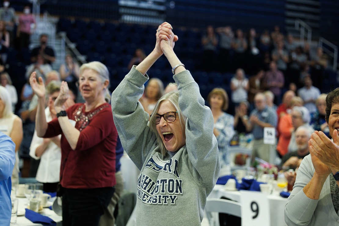 Maryann Willis cheers enthusiastically as speaker Lynda Goodrich is announced at the ceremony.