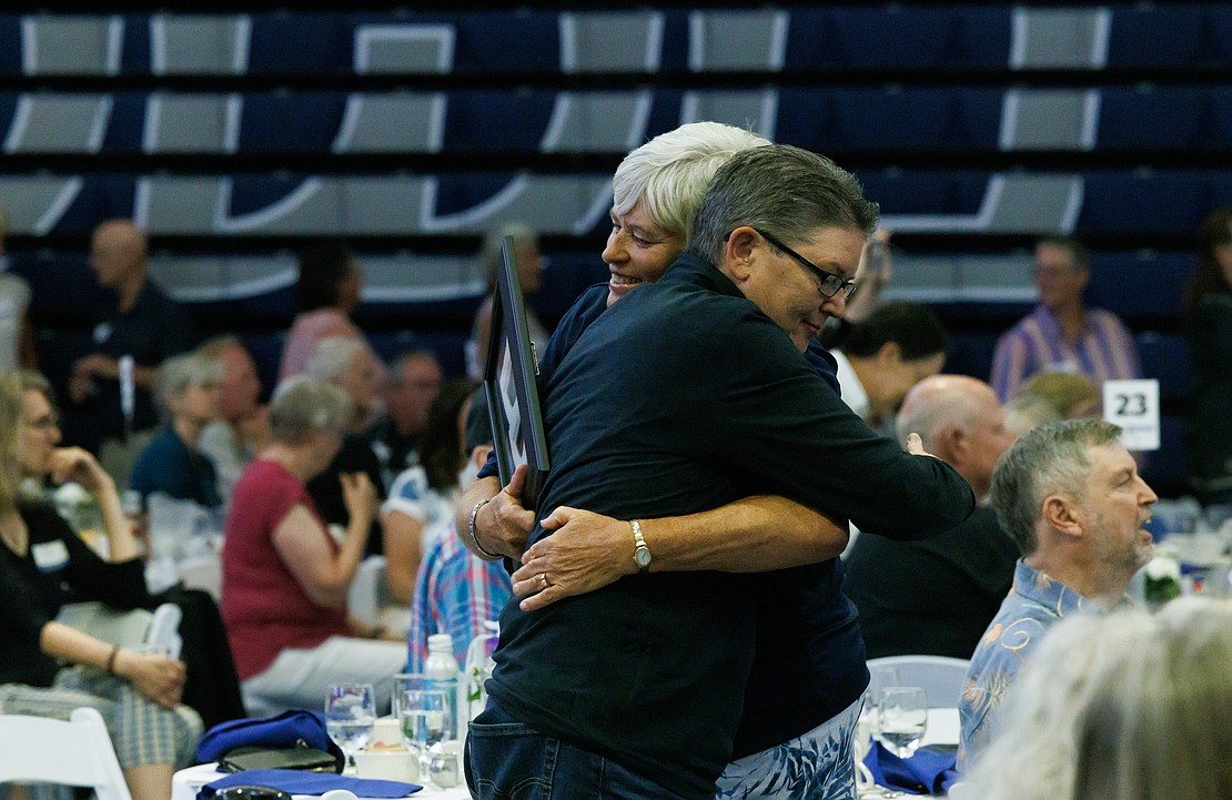 Jo Metzger-Levin, left, hugs former teammate Mitzi Johanknecht during the ceremony.
