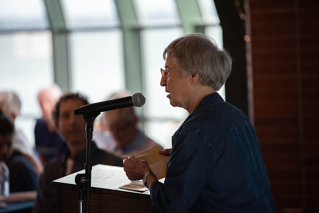Evelyn Ames, who coached the first intercollegiate competition of the women's basketball program in 1965, reads a telegram she received when she coached.