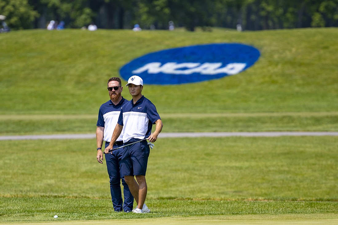 Western Washington University senior Jordan Lee, right, and coach Luke Bennett eye Lee's next shot May 24 at the NCAA Division II Men's Golf National Championships at Avalon Lakes Country Club in Warren, Ohio. Lee finished second overall individually.