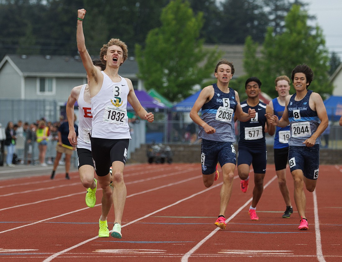 Sehome's Zack Munson raises a fist in the air as he crosses the finish line May 27 to win the 2A boys 800-meter run, his second state title of the three-day 2A state championship meet at Mount Tahoma High School. Bellingham's William Giesen, left, finished second and Squalicum's Chase Barlett, middle, finished third. Squalicum's Wesley Sluys, right, finished fifth.
